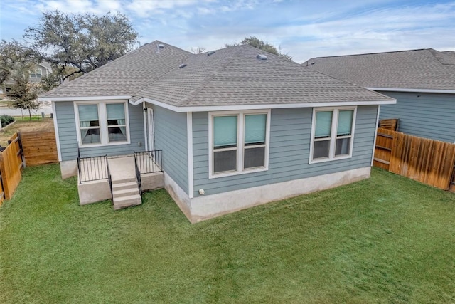 rear view of house featuring a yard