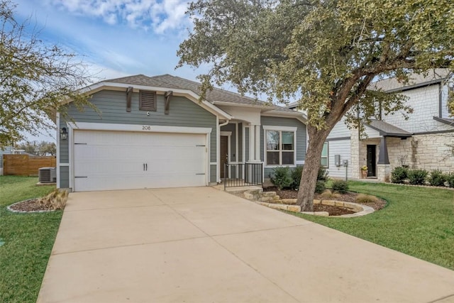 view of front of home with a garage, a front yard, and central air condition unit