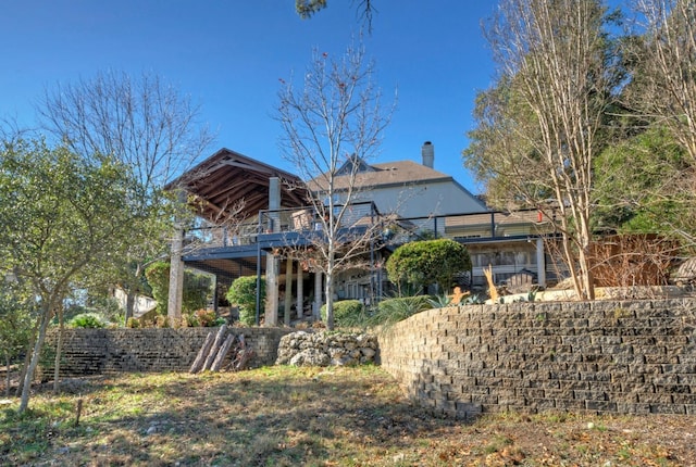 rear view of house with a wooden deck