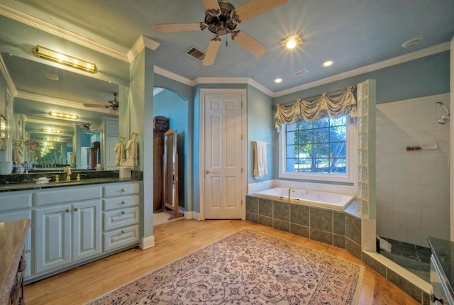 bathroom with hardwood / wood-style floors, crown molding, and plus walk in shower