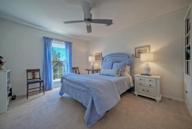 bedroom with ornamental molding, light carpet, and ceiling fan