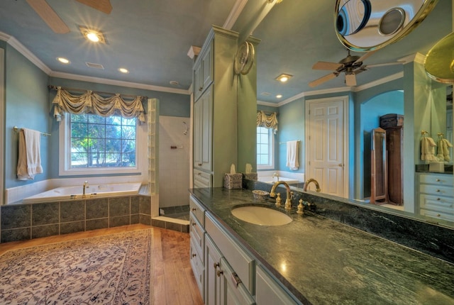 bathroom featuring crown molding, ceiling fan, hardwood / wood-style floors, vanity, and plus walk in shower