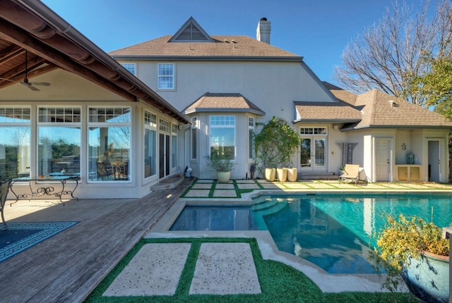 view of swimming pool with a deck and ceiling fan