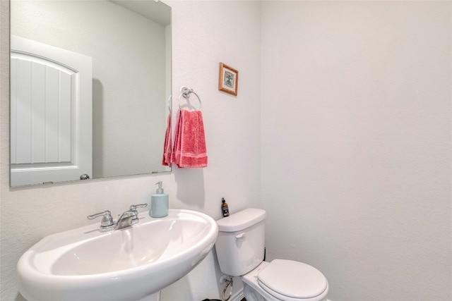 bathroom featuring sink and toilet