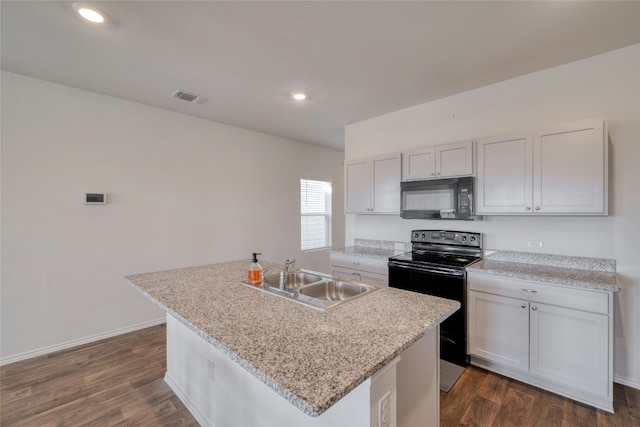 kitchen featuring white cabinetry, sink, dark hardwood / wood-style flooring, a kitchen island with sink, and black appliances