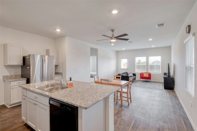 kitchen with stainless steel refrigerator, white cabinetry, dishwasher, sink, and a center island with sink