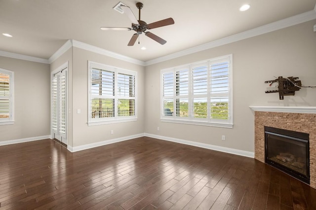 unfurnished living room with crown molding, a wealth of natural light, and dark hardwood / wood-style floors