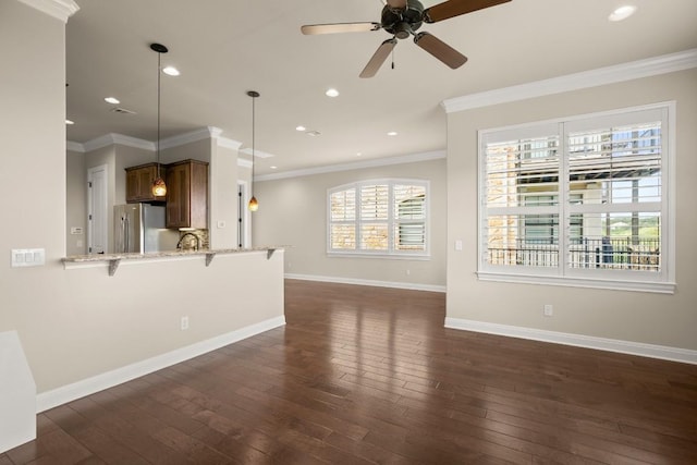 unfurnished living room with ceiling fan, ornamental molding, and dark hardwood / wood-style flooring