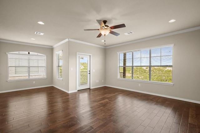 spare room featuring dark wood-type flooring, ornamental molding, and ceiling fan