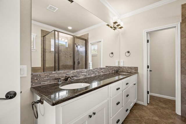 bathroom featuring ornamental molding, vanity, backsplash, and a shower with shower door