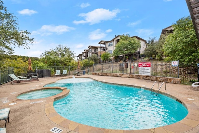 view of swimming pool with a patio and a community hot tub