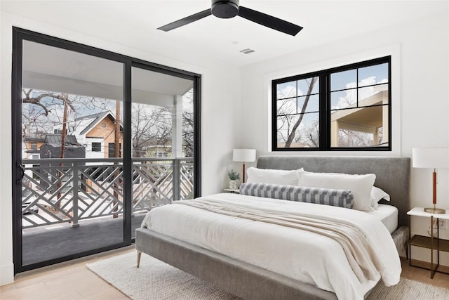 2709 Stacy Ln Unit 1, Austin, TX 78704 - bedroom with wood finished floors, access to outside, and a ceiling fan