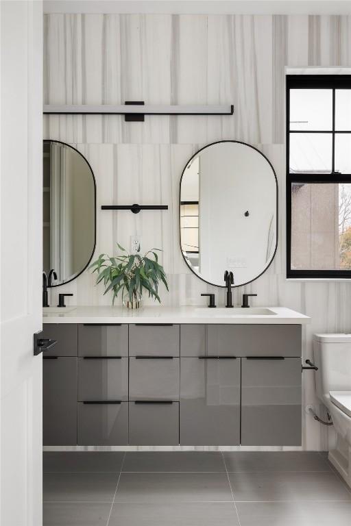 2709 Stacy Ln Unit 1, Austin, TX 78704 - bathroom with double vanity, toilet, and tile patterned floors
