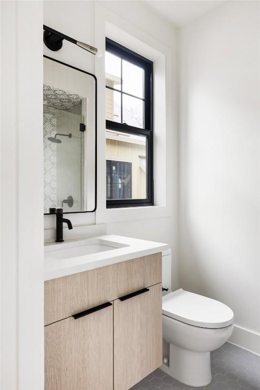 2709 Stacy Ln Unit 1, Austin, TX 78704 - full bath featuring vanity, tile patterned floors, toilet, and a tile shower