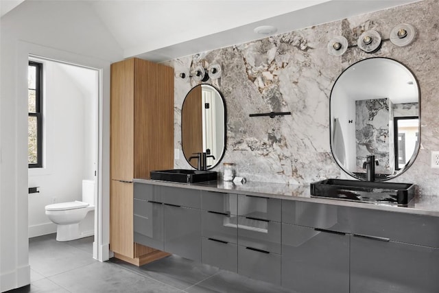 2709 Stacy Ln Unit 1, Austin, TX 78704 - bathroom featuring double vanity and vaulted ceiling