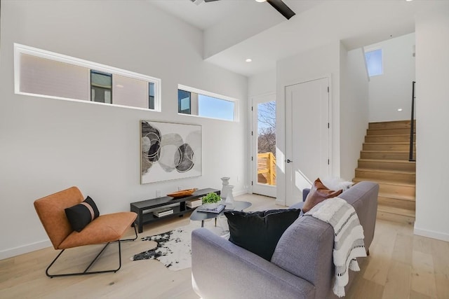 living room with ceiling fan and light hardwood / wood-style floors