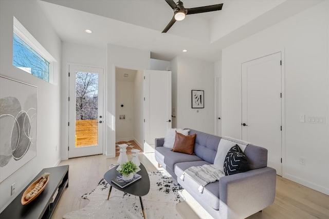 living room with ceiling fan and light wood-type flooring