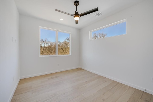 spare room featuring ceiling fan and light hardwood / wood-style flooring