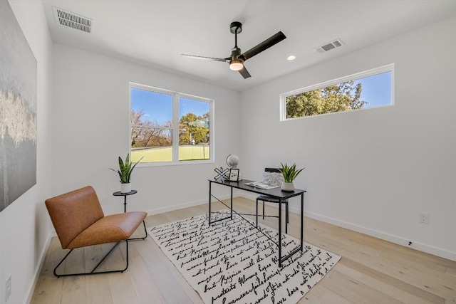 home office featuring ceiling fan and light hardwood / wood-style flooring