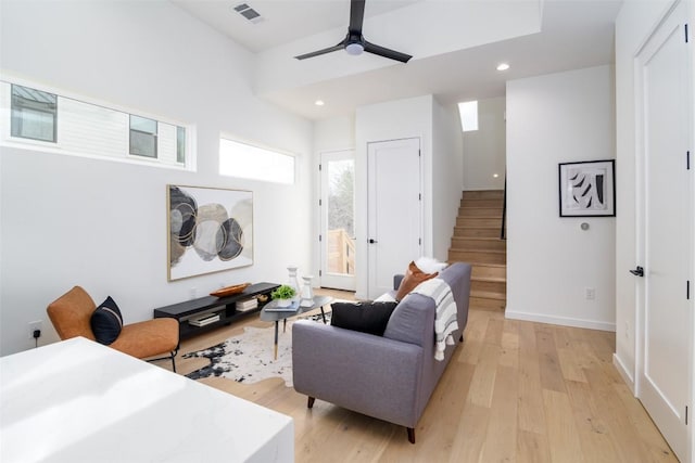 living area with visible vents, light wood-style flooring, recessed lighting, stairway, and ceiling fan