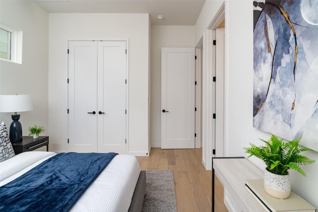 bedroom with a closet and light wood-style floors