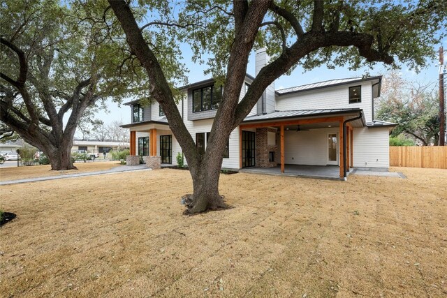 view of front facade with a front lawn and a patio area