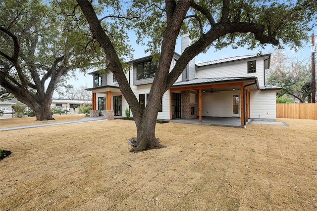 view of front of house featuring a front lawn and a patio area