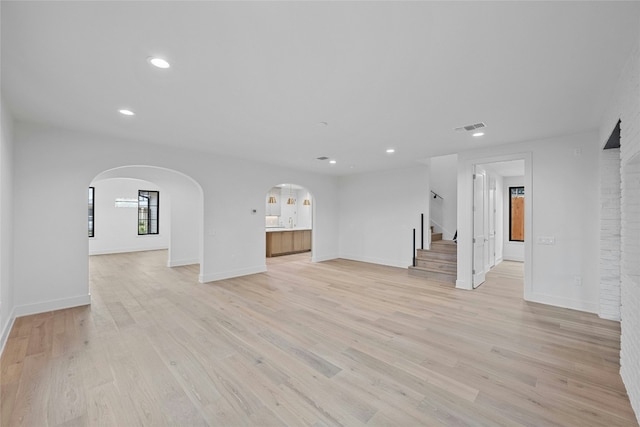 unfurnished living room featuring light hardwood / wood-style flooring