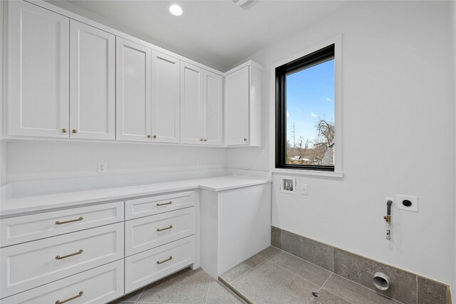 washroom with cabinets, gas dryer hookup, electric dryer hookup, and hookup for a washing machine