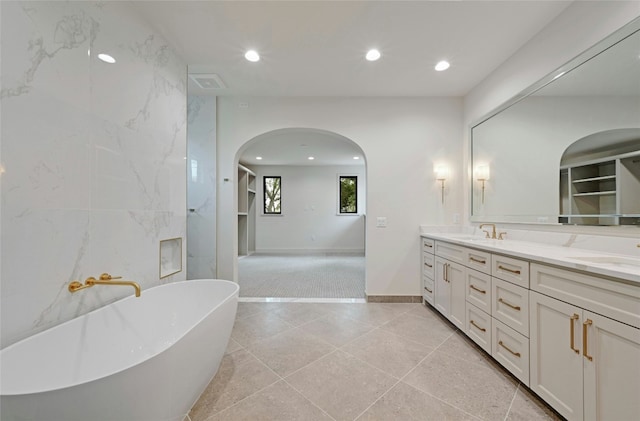 3008 W 50th St, Austin, TX 78731 - full bathroom with double vanity, a freestanding tub, recessed lighting, and tile patterned flooring
