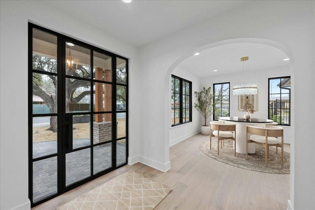3008 W 50th St, Austin, TX 78731 - dining area with arched walkways, wood finished floors, recessed lighting, and a chandelier