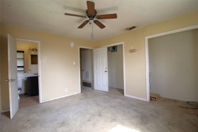 2810 Inwood Rd, Temple, TX 76502 - unfurnished bedroom with carpet floors, connected bathroom, a textured ceiling, and ceiling fan