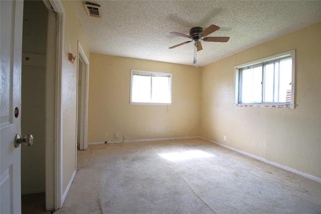 2810 Inwood Rd, Temple, TX 76502 - unfurnished bedroom featuring carpet floors, a textured ceiling, and a ceiling fan