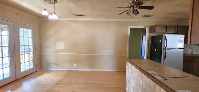 2810 Inwood Rd, Temple, TX 76502 - unfurnished dining area featuring crown molding, light wood finished floors, plenty of natural light, a ceiling fan, and french doors