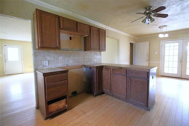 2810 Inwood Rd, Temple, TX 76502 - kitchen featuring plenty of natural light, ceiling fan, decorative backsplash, light wood-style flooring, and ornamental molding