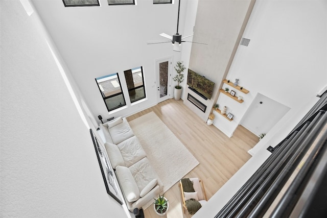 living room featuring wood-type flooring and a high ceiling