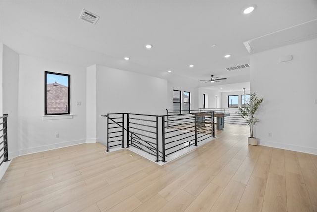 interior space featuring light wood-style floors, baseboards, visible vents, and recessed lighting