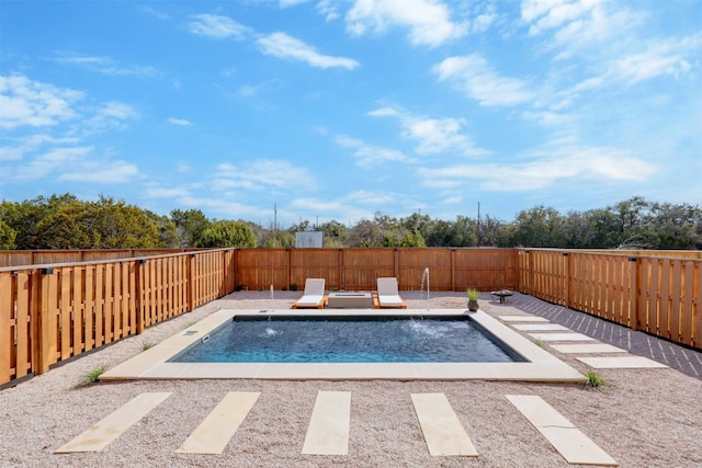 view of swimming pool featuring pool water feature and a patio