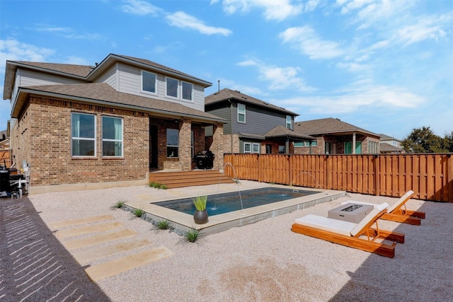 view of pool featuring a patio area and a fire pit