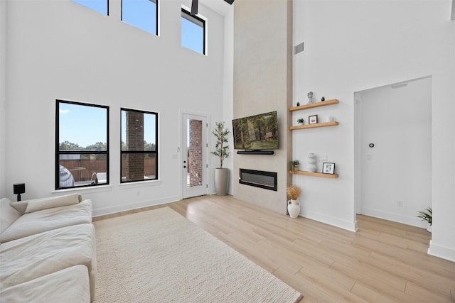 living room with a wealth of natural light and light hardwood / wood-style floors