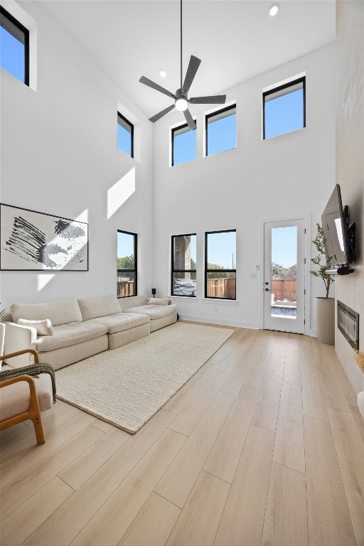 living room with ceiling fan and light hardwood / wood-style floors