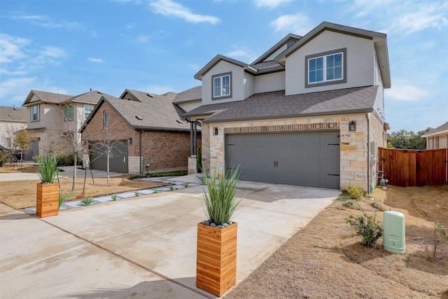 traditional-style home featuring an attached garage, stone siding, concrete driveway, and stucco siding