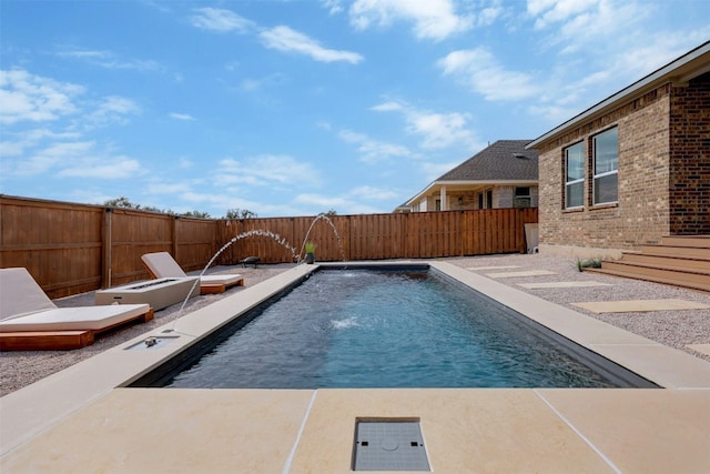 view of swimming pool featuring pool water feature and a patio