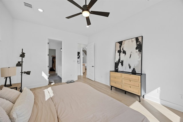 bedroom featuring baseboards, recessed lighting, visible vents, and light wood-style floors