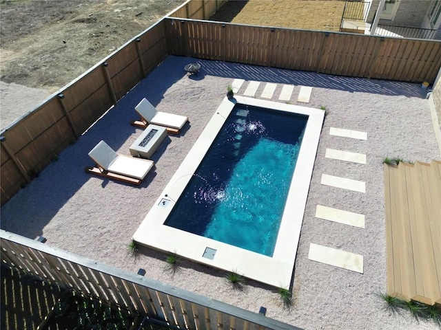 view of pool with a fenced backyard