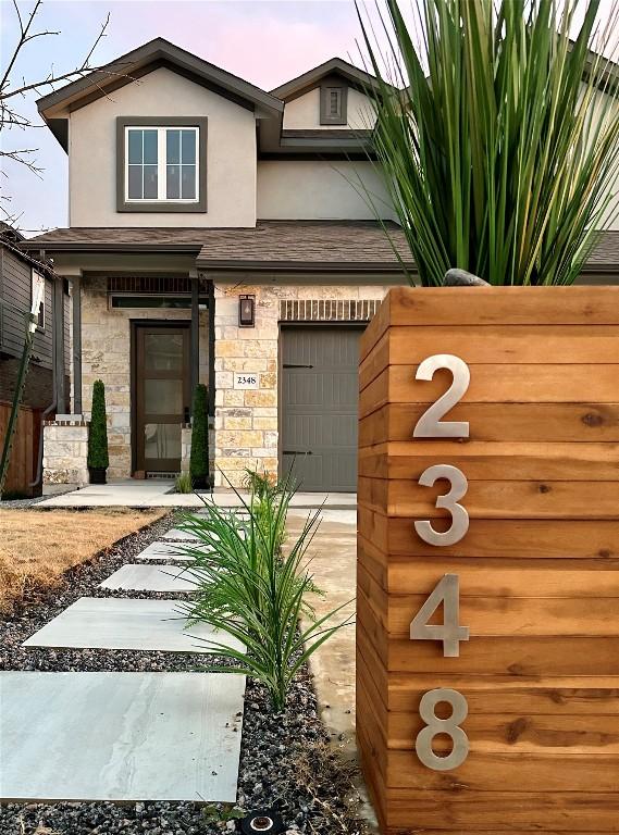 exterior space with stone siding and stucco siding