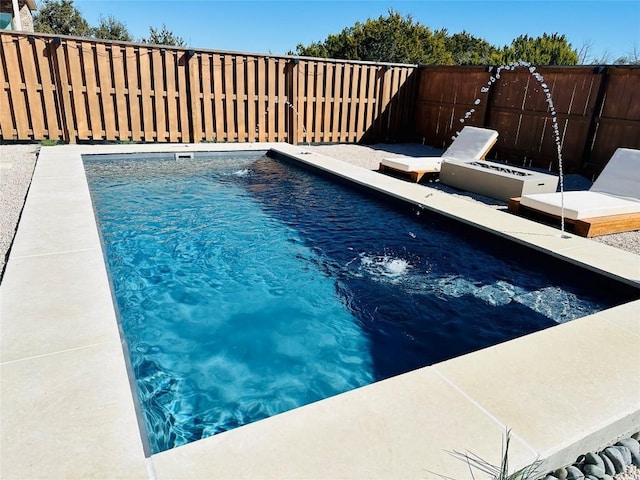 view of swimming pool with a fenced backyard and a fenced in pool