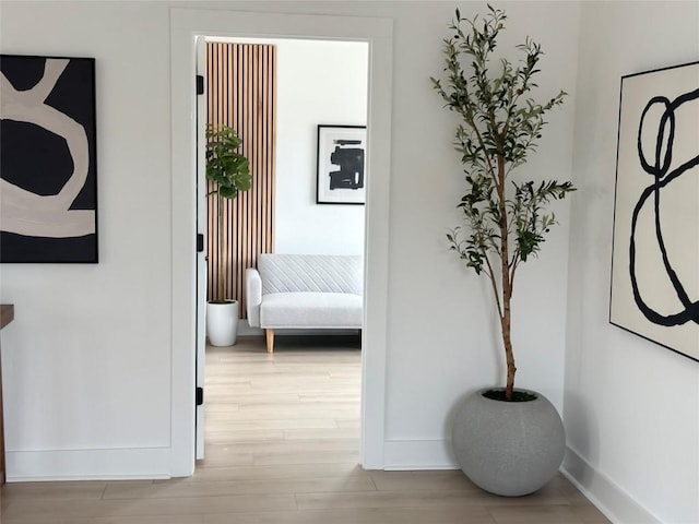 hallway with wood finished floors and baseboards