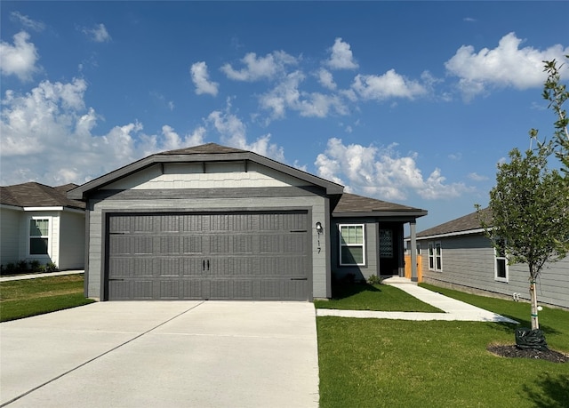 ranch-style home with a garage and a front lawn