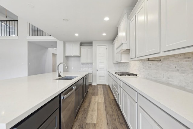 kitchen featuring white cabinetry, sink, dark hardwood / wood-style flooring, and appliances with stainless steel finishes